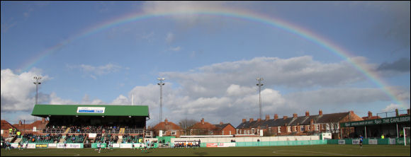 The main stand in front of a rainbow at Croft Park