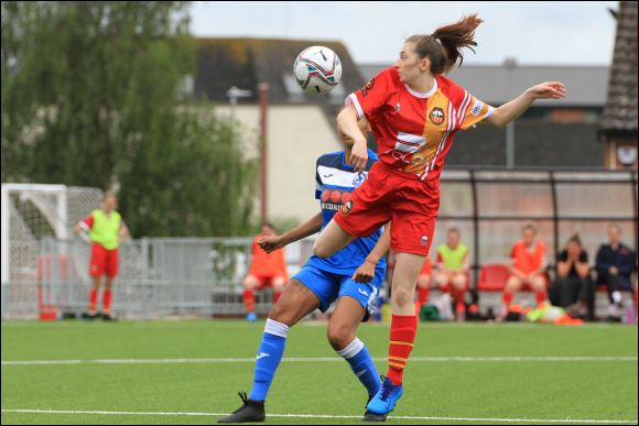 Abbie jumps for a header against Larkhall Athletic in a pre-season friendly in July 2021