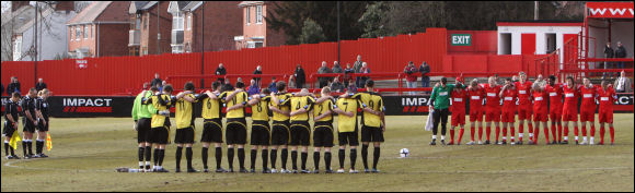Both teams observe a minutes silence for the late Macclesfield Town manager Keith Alexander