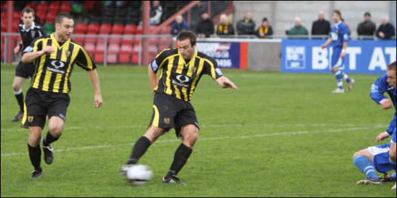 Mike Symons wraps his right foot around the ball to score against Gainsborough
