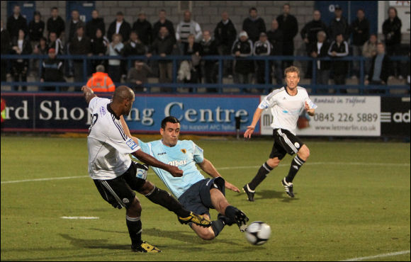 Tom Hamblin tries but fails to stop Phil Trainer scoring for Telford