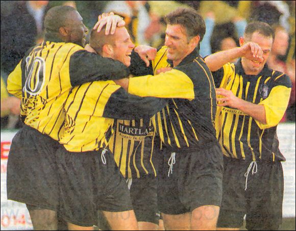 Jon Holloway is mobbed by Adie Mings and Steve Fergusson after giving the Tigers the lead against Wisbech