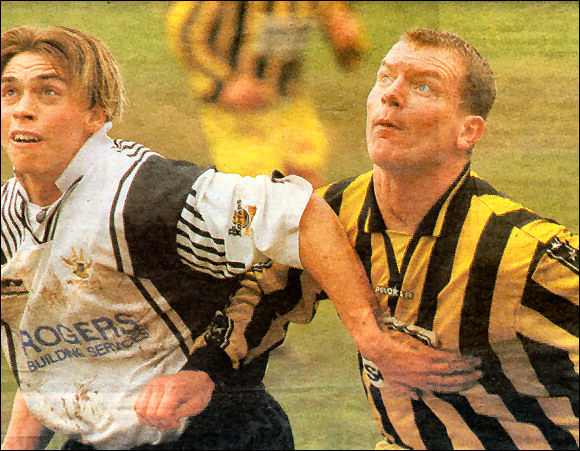 Karl Bayliss gets to grips with Salisbury's Scott Bartlett, who is a former Cirencester Town player